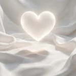Glowing white heart shape on soft white silk fabric